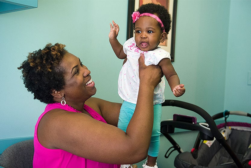 Neangela Dixon smiles at Ryleigh, her daughter concieved and born after Neangela's minimally invasive fibroid surgery