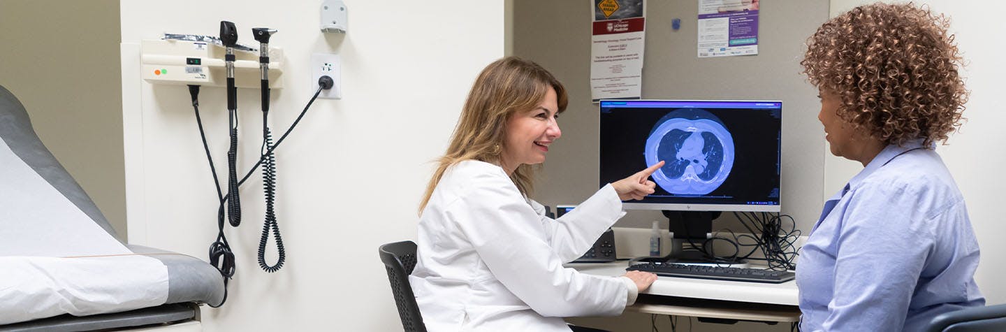 Dr. Marina Garassino consults on a digital scan in a clinical setting.