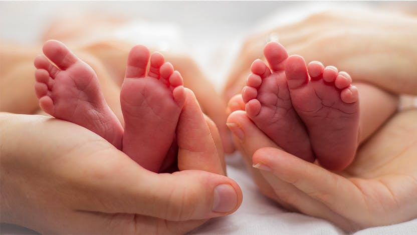 Image of parent holding small baby feet