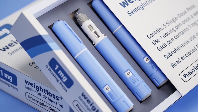 a box labeled weightloss plus is slightly open to reveal several blue drug injector pens
