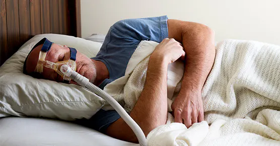 Image of individual sleeping with CPAP mask