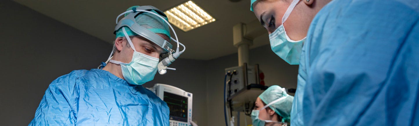Surgeons in full surgical gear during operation