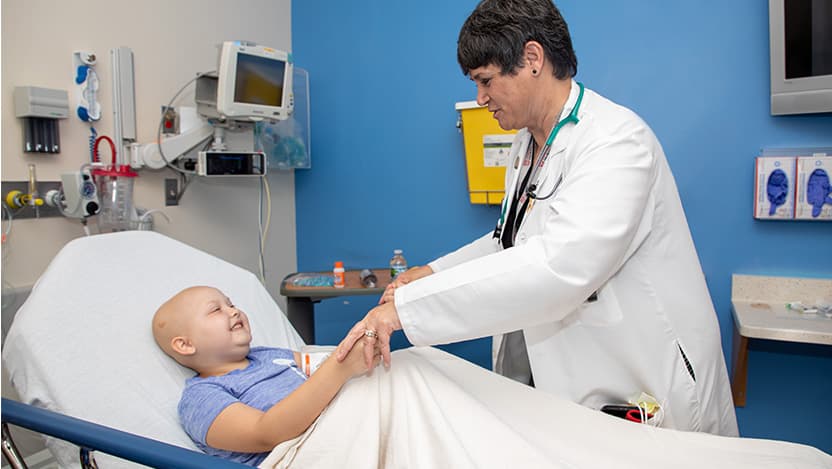 Kelly Kramer working with a pediatric cancer patient