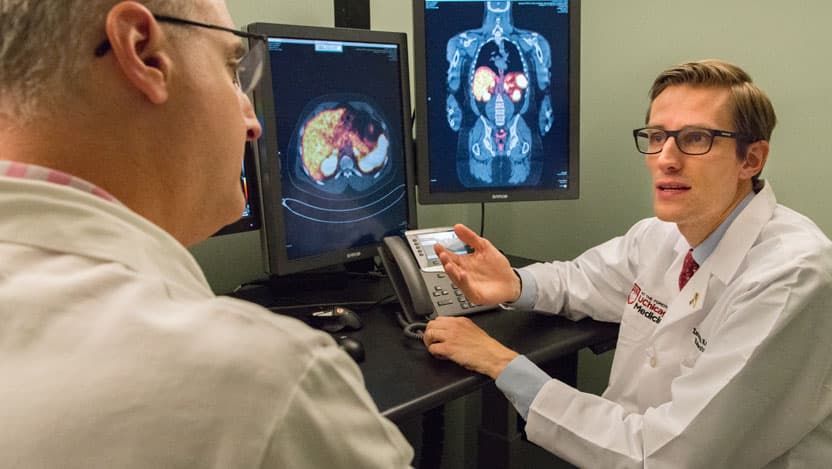 Xavier Keutgen, MD, right, talks with Daniel Appelbaum, MD
