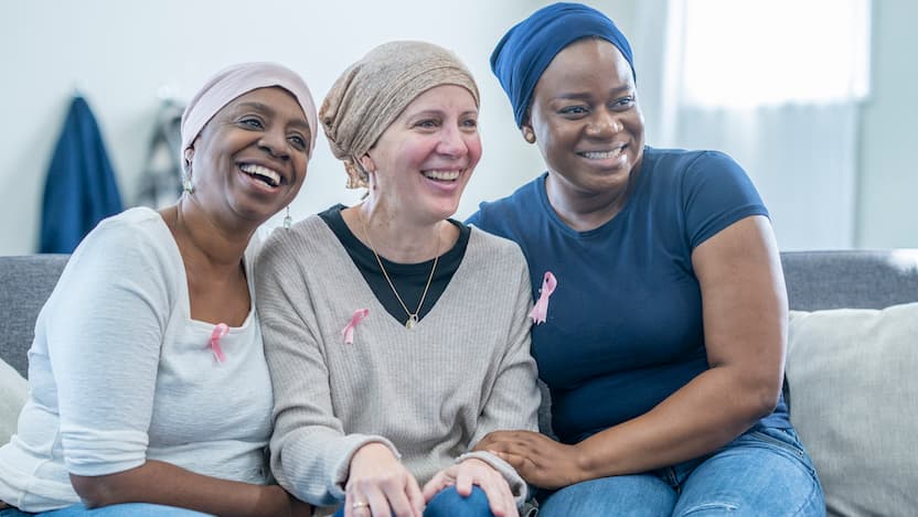 Photo of women wearing breast cancer awareness ribbon pins