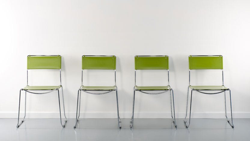 four empty chairs in a hallway