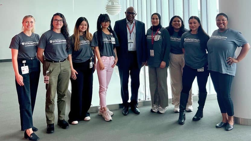 First cohort of interns pose with Kunle Odunsi, MD, PhD, and program leaders after a meeting.