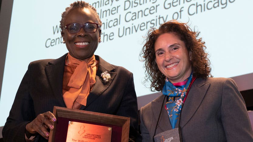 Olufunmilayo (Funmi) Olopade, MD, FASCO, FACP, OON, with Virginia G. Kaklamani, MD, (right) during the William L. McGuire Memorial Lecture, Wednesday December 8, 2021. Photo by © MedMeetingImages/Todd Buchanan 2021
