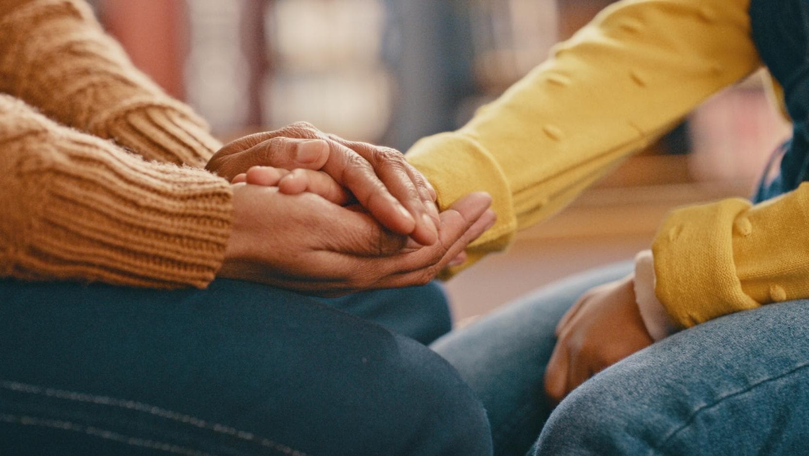 two sets of hands holding each other