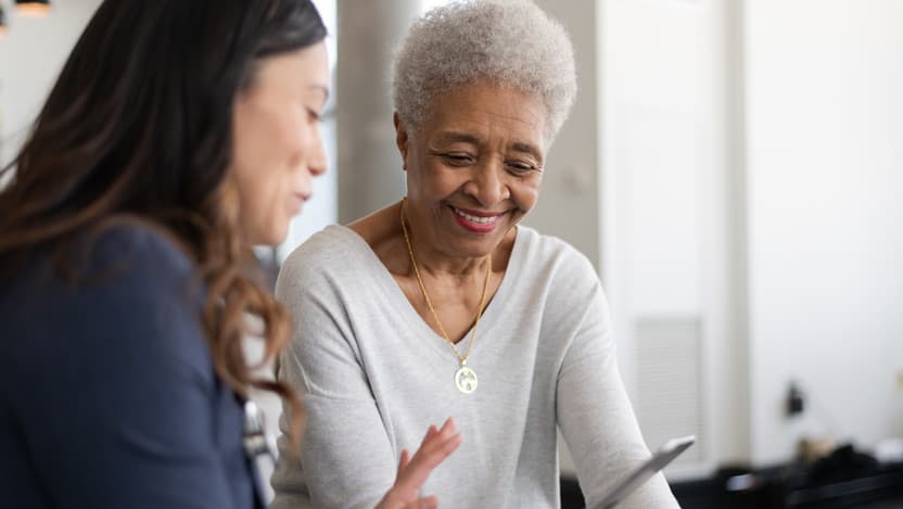 younger woman showing cell phone to older woman