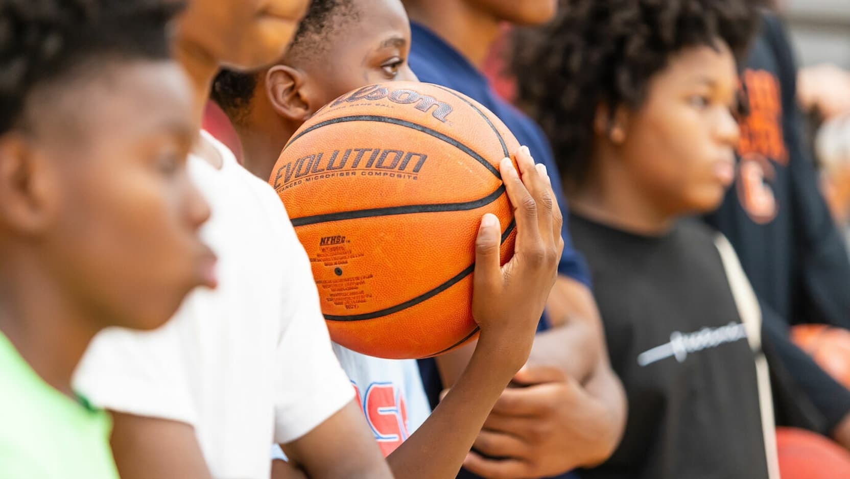 kids with basketball at Sneakers to Scrubs