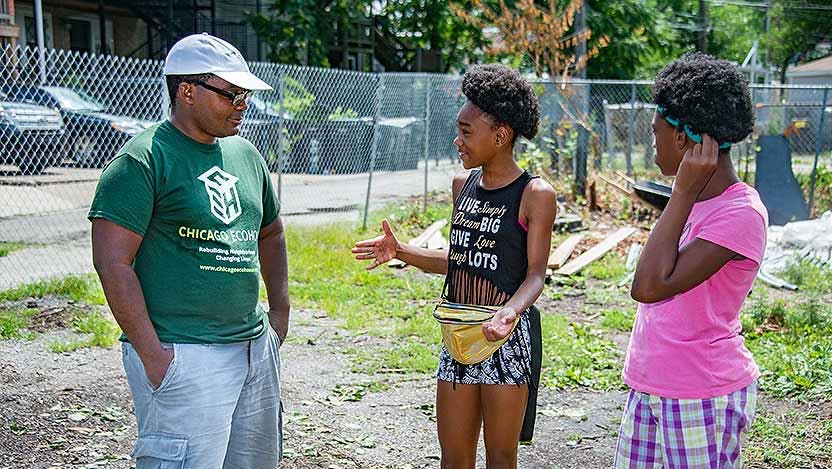 Chicago Eco House's Quilen Blackwell works with two young participants in the group's summer program.