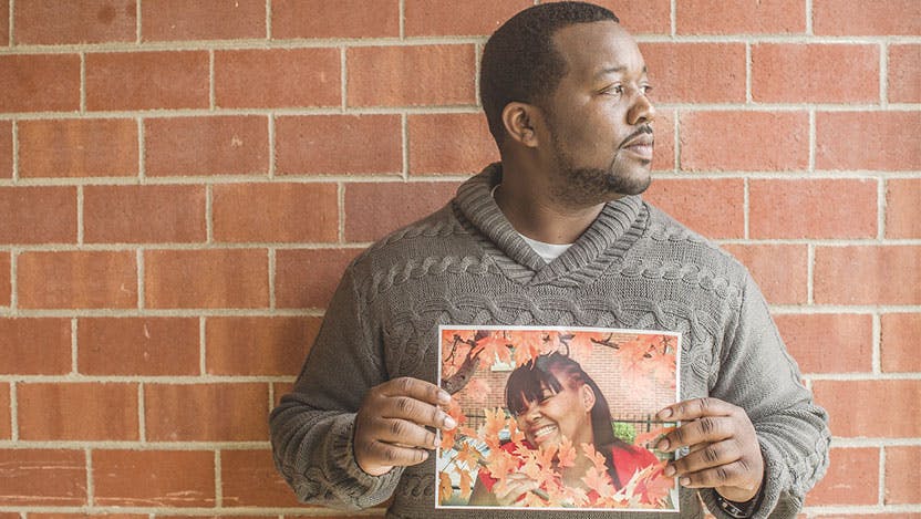 Violence recovery specialist Martinez Sutton holds a photo of his late sister, Rekia Boyd