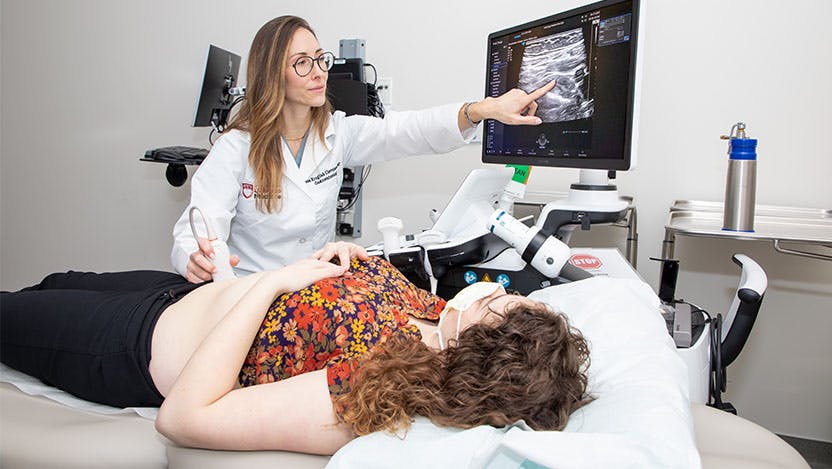 Noa Krugliak Cleveland, MD, performs an ultrasound on a patient.