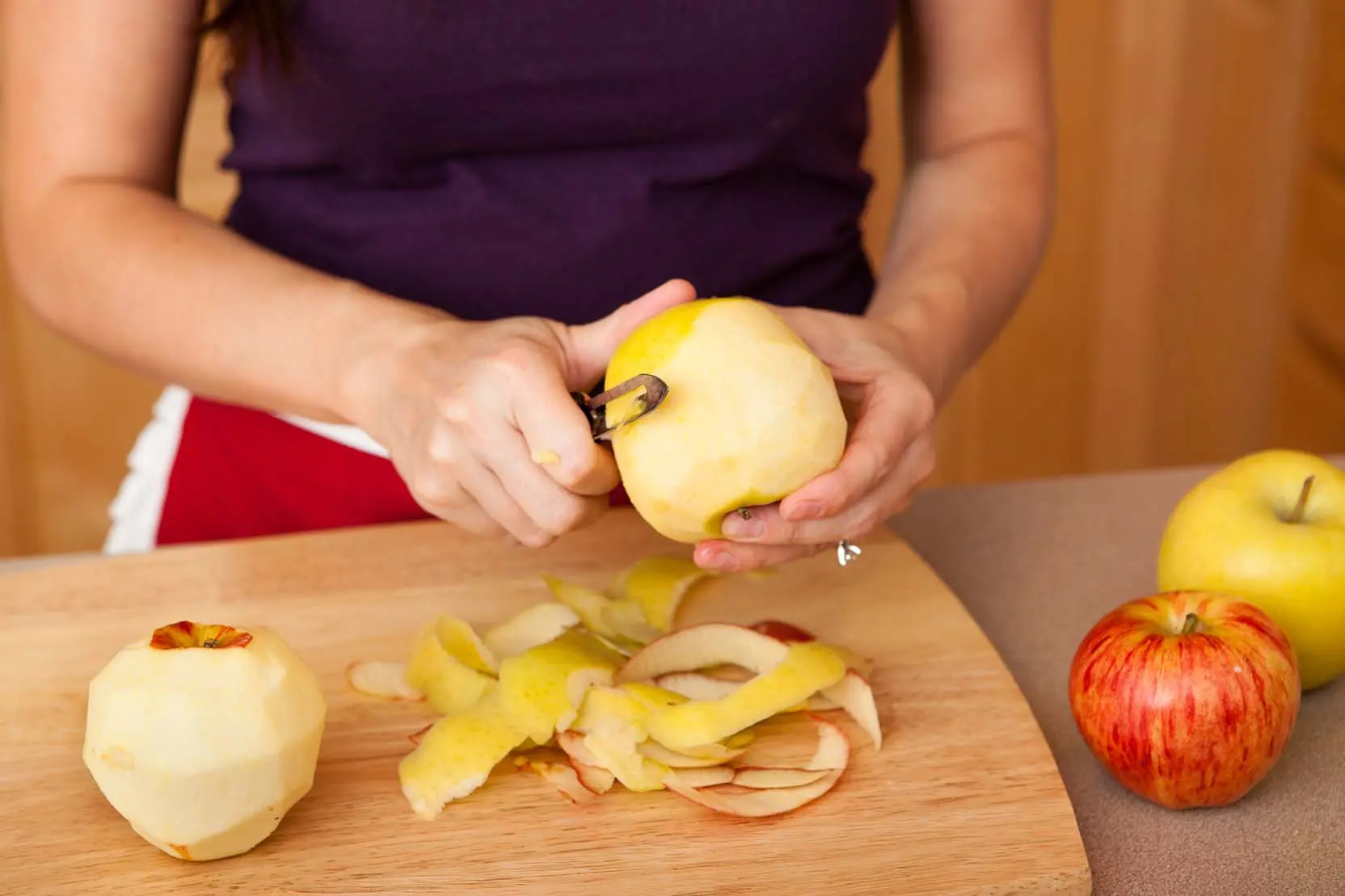 person peeling apple