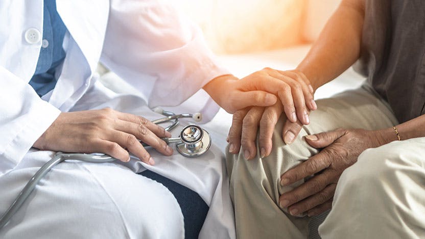 Geriatric doctor consulting examining elderly senior aged adult in medical exam clinic or hospital stock photo
