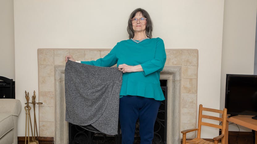 Margaret Johnson holding up skirt that no longer fits due to significant weight loss