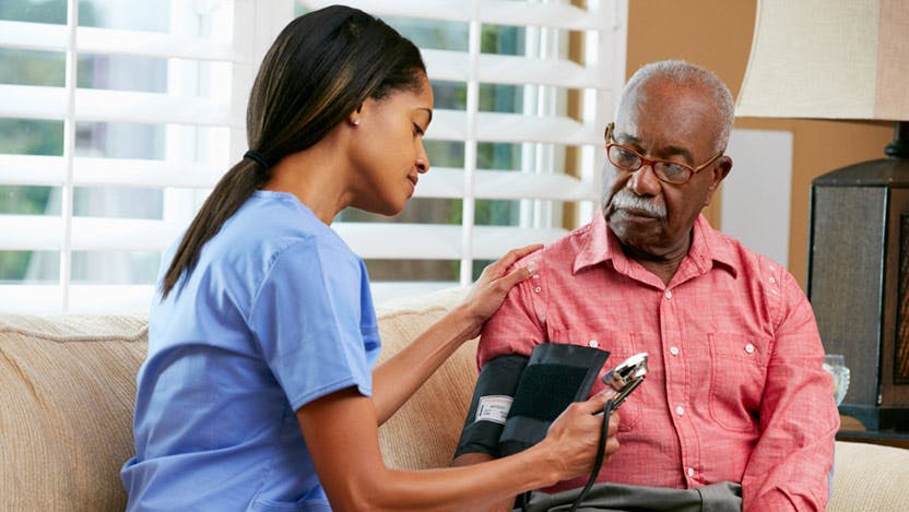 A nurse taking a man's blood pressure