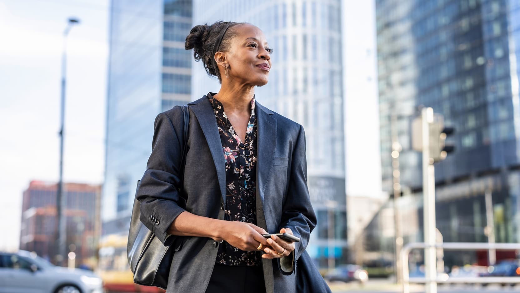 mature business woman in city with phone