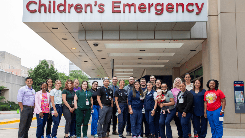 Comer staff stands in front of Children's Emergency entrance