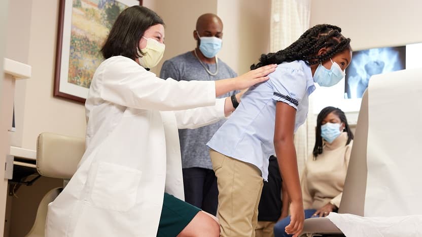 Dr. Clarabelle DeVries working with pediatric patient