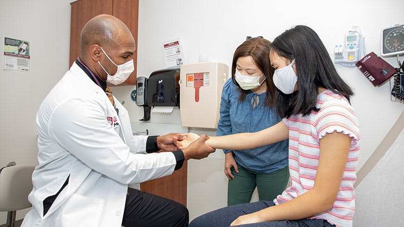 Anwar Isabell, MD, working with patients at urgent care clinic