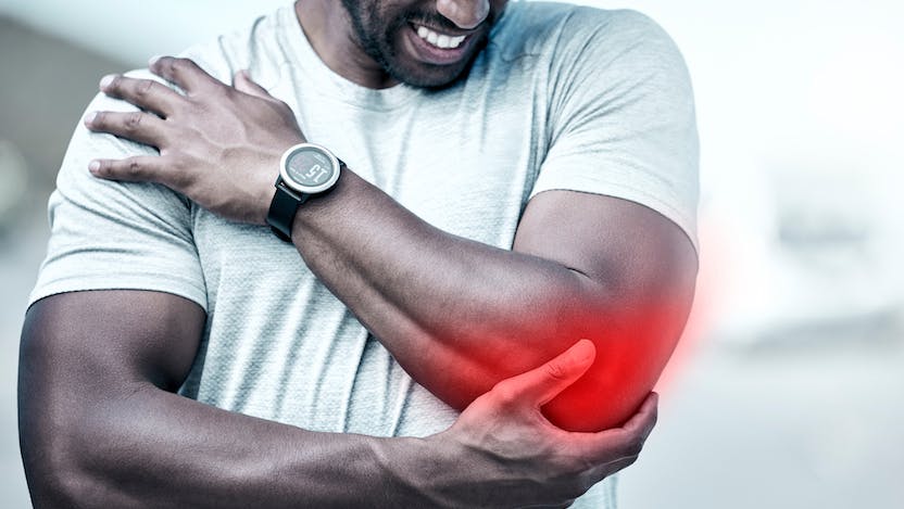 Photo of man grasping elbow with red illustration of pain radiating out of it