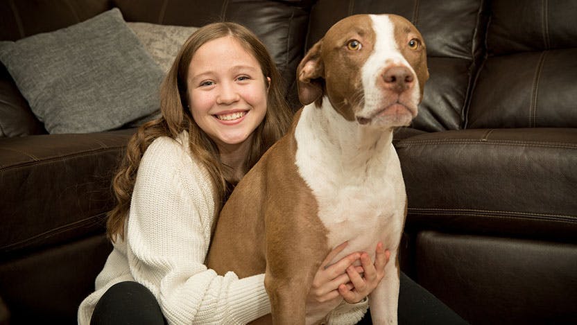 Image of pediatric epilepsy patient Bailey Harding with her dog