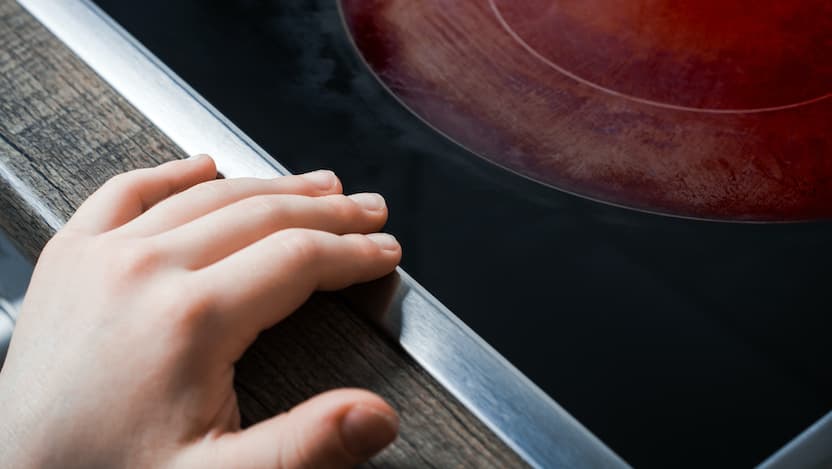 child's hand on hot stove