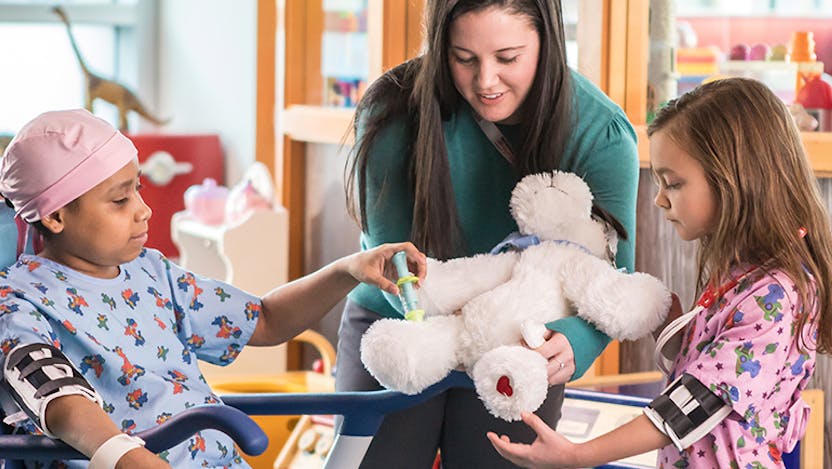 Child Life specialist with children in the playroom
