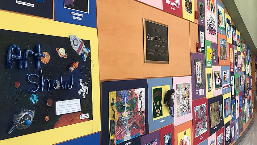 Wall of artwork displayed in 2019 Comer Art Show