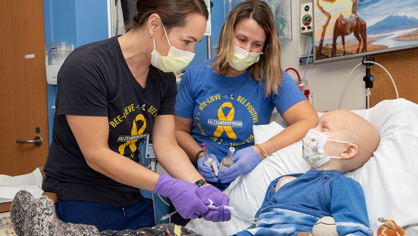 Courtenay Lutz, BSN, RN, CPNP-PC, CPHON and Caitlyn Francis, BSN, RN do a safety cross-check as they access five-year-old Alexander Brown’s central line.