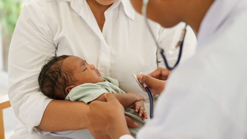 Photo of a physician examining a newborn