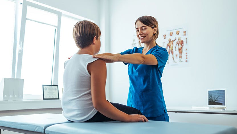 Image of medical provider doing a physical exam with a pediatric patient