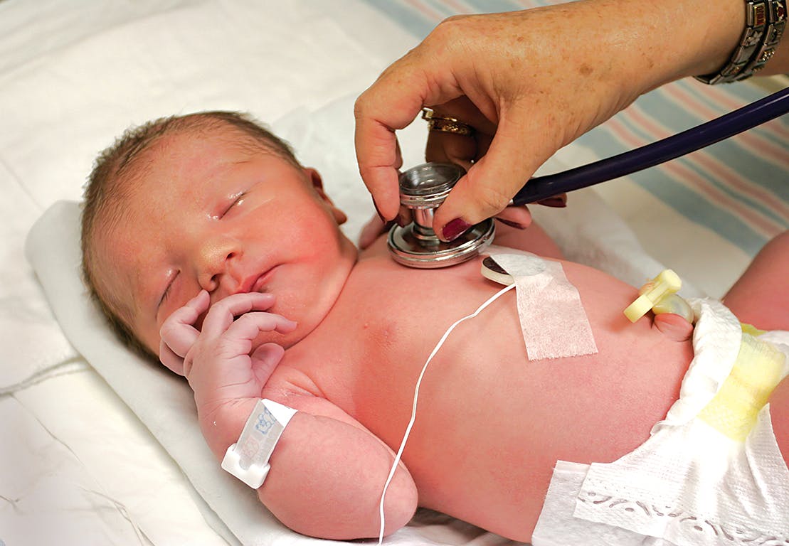 Newborn being checked by doctor