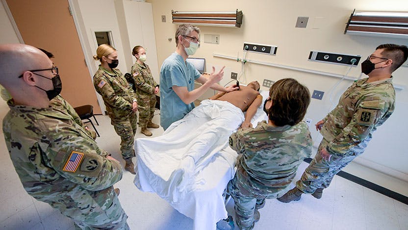 Trauma surgeon Nicholas Jaszczak, MD, teaches a group of Army medics and advanced practice nurses