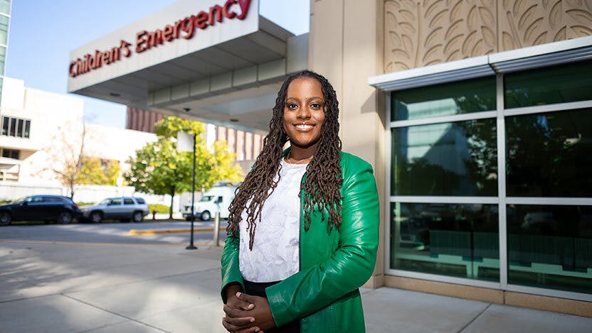 Christine Goggins standing in front of the Comer Children's Hospital Emergency Room.