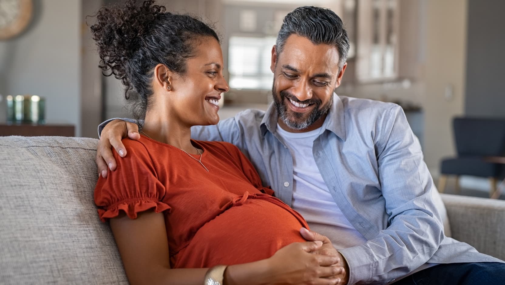 pregnant woman and male partner smiling