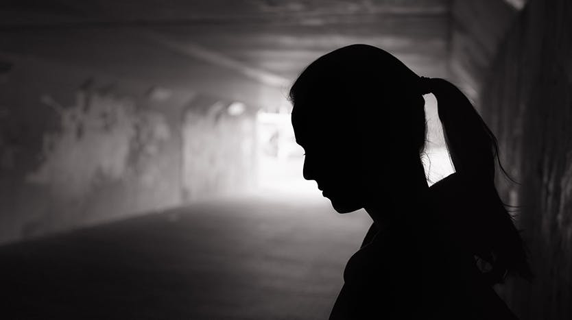 Depressed young woman in tunnel