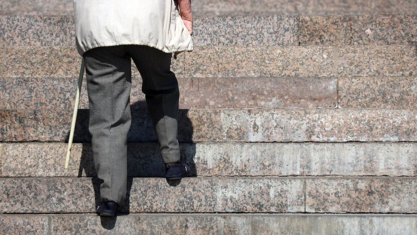Elderly person walking up stairs
