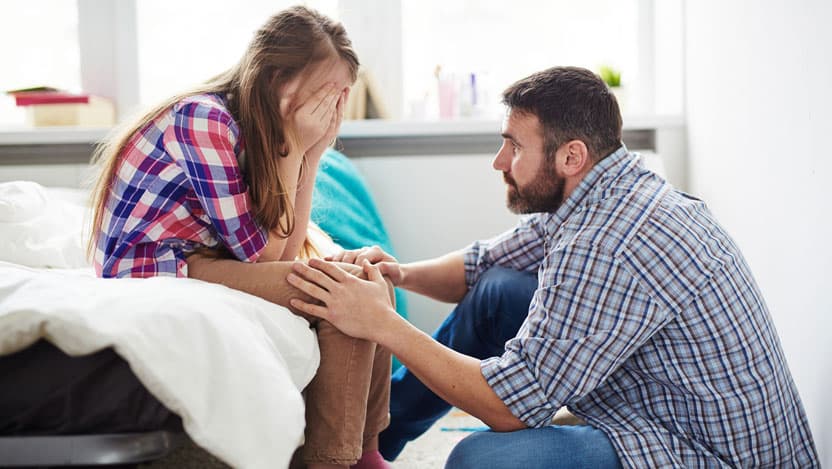 father comforting daughter