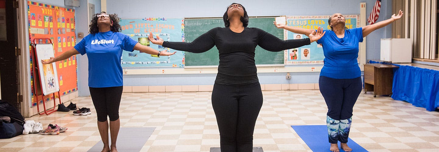Women practicing yoga in UHI South Side Fit program