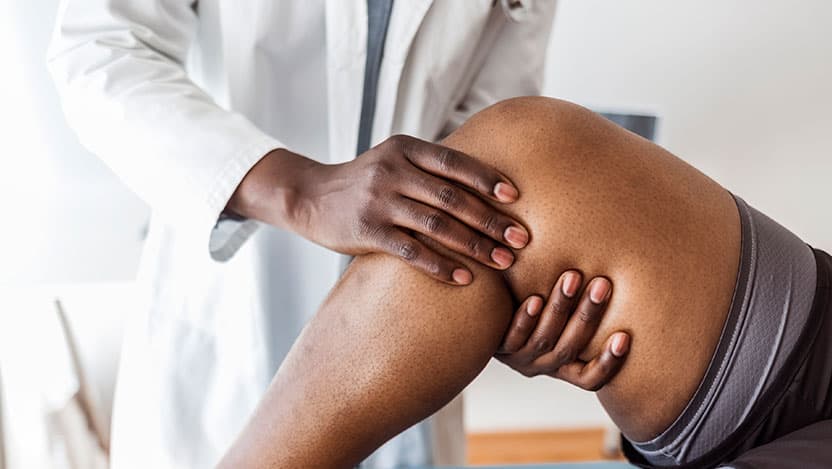 Doctor examining patient's knee