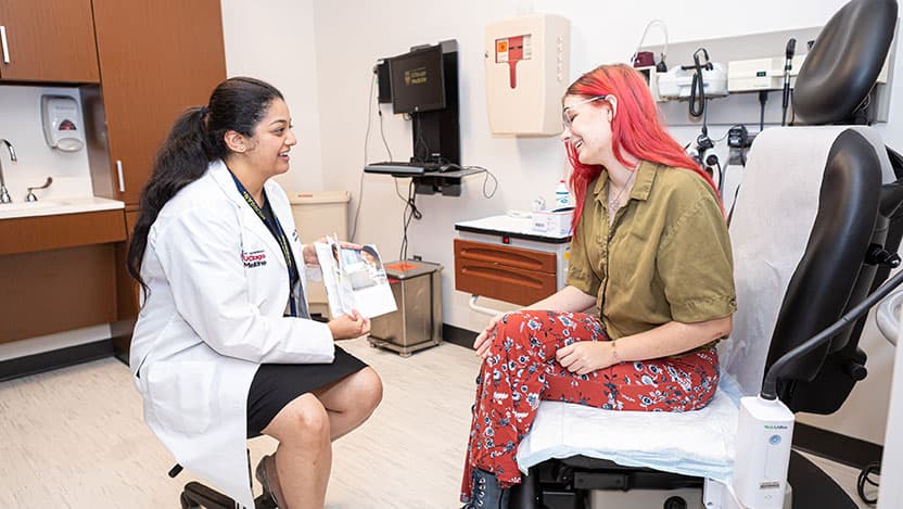 Shashwati Pradhan, MD, (left), speaks with a patient at UChicago Medicine.