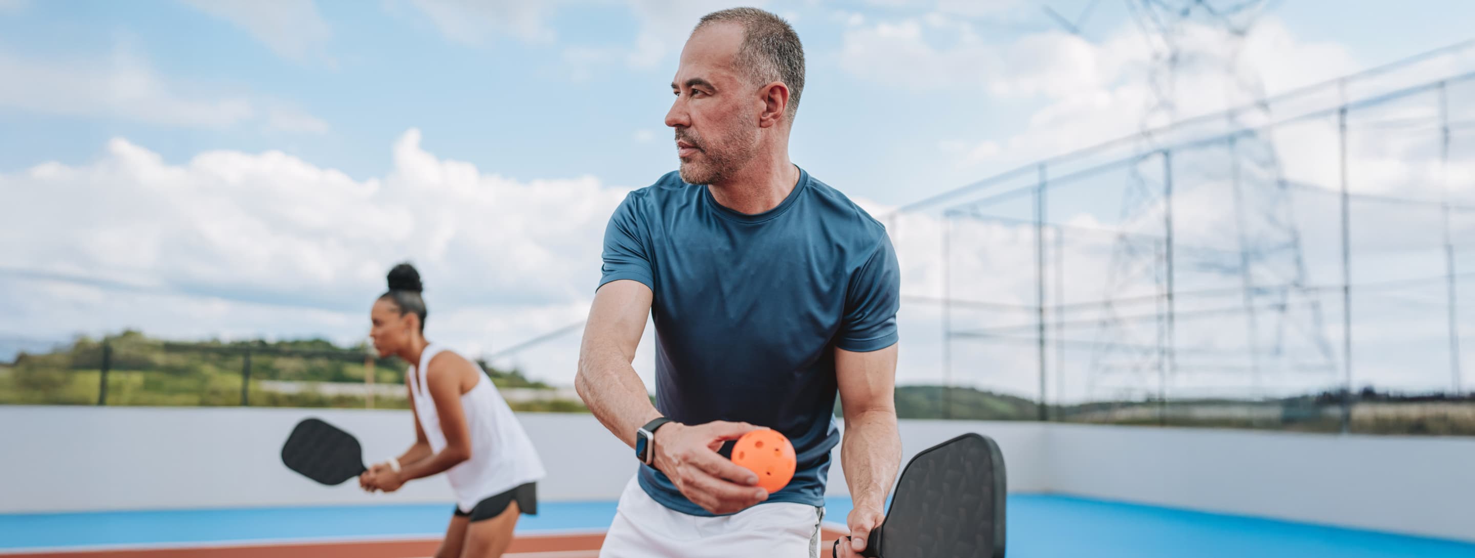 Adults playing pickleball
