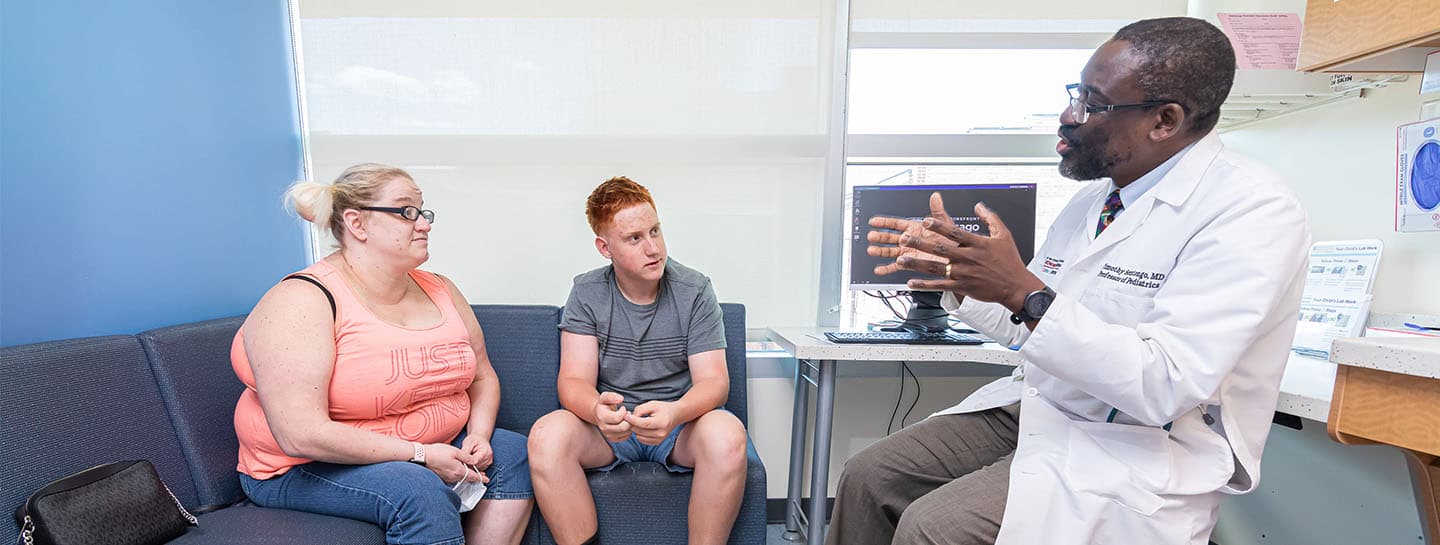 Image of Dr. Sentongo working with pediatric gastroenterology patient