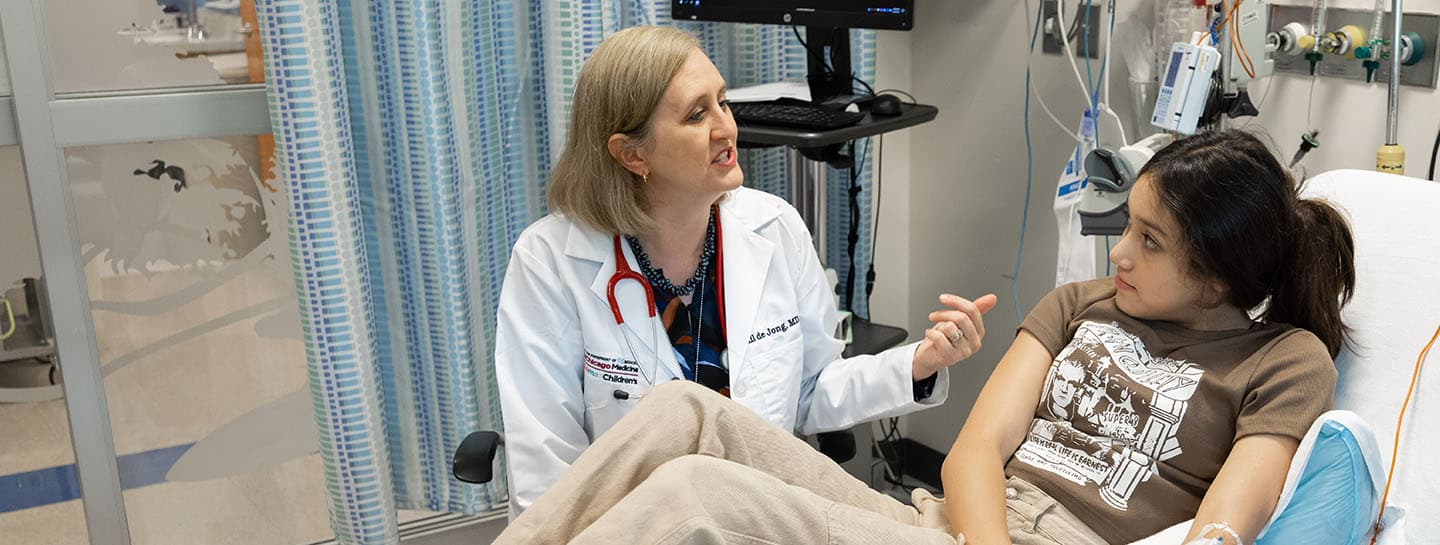 Image of Dr. de Jong working with pediatric patient