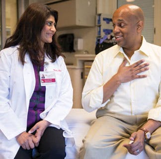 Sonali Smith, MD, talks with Clayton Harris, a lymphoma patient