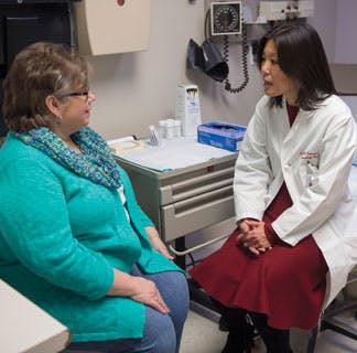Gynecologic oncologist S. Diane Yamada, MD, meets with a patient