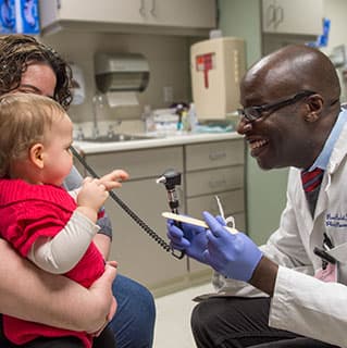 Plastic and reconstructive surgeon Russell Reid, MD, PhD., with Trish Lawson and her daughter Molly Lawson, 15 months old, at the Duchossois Center for Advanced Medicine (DCAM)
